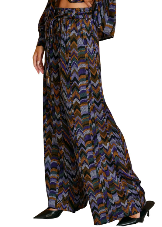 Patterned pants worn by a person on a beige background