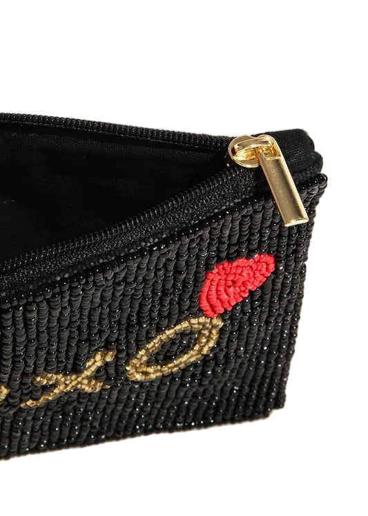 Black beaded pouch with red lip design and gold text on a white background