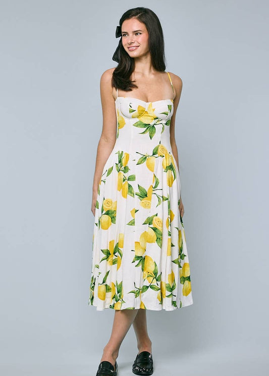 Woman wearing a dress with lemon print on a gray background