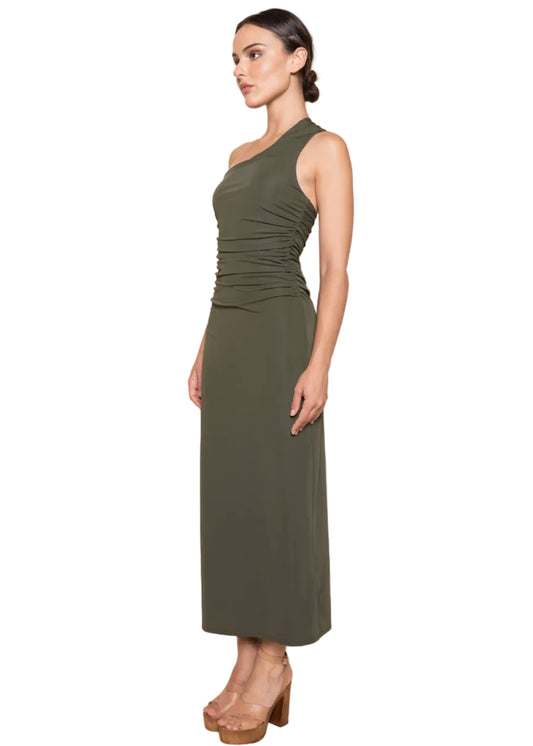 Woman wearing a green dress against a beige background