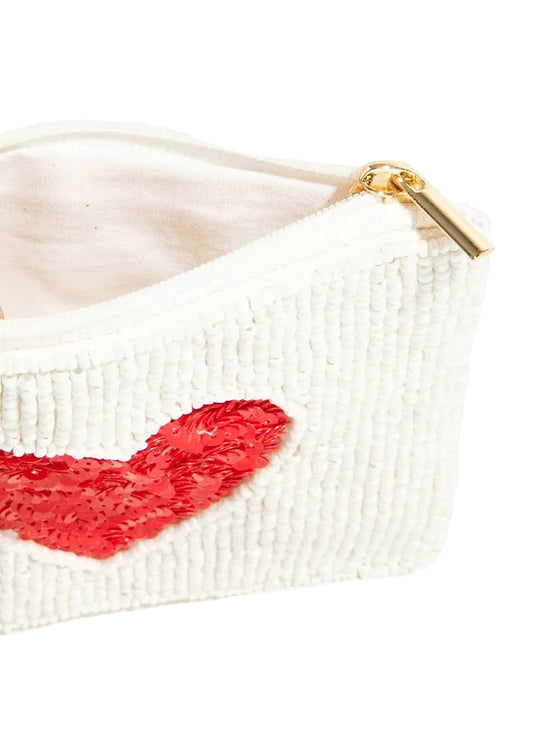 White beaded pouch with a red heart design and gold zipper on a white background