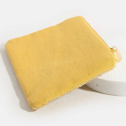 Yellow pouch with a gold zipper on a white background
