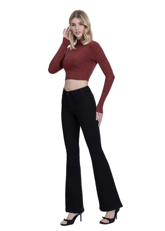 Woman wearing a red sweater and black flared pants on a white background