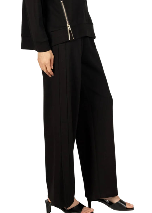 Person wearing a black outfit with wide-leg pants on a white background