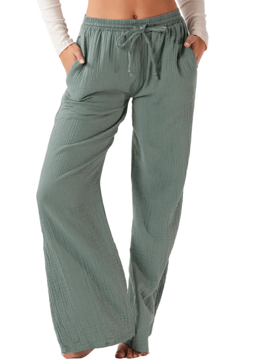 A pair of green wide-leg cabana pants with a drawstring waist.