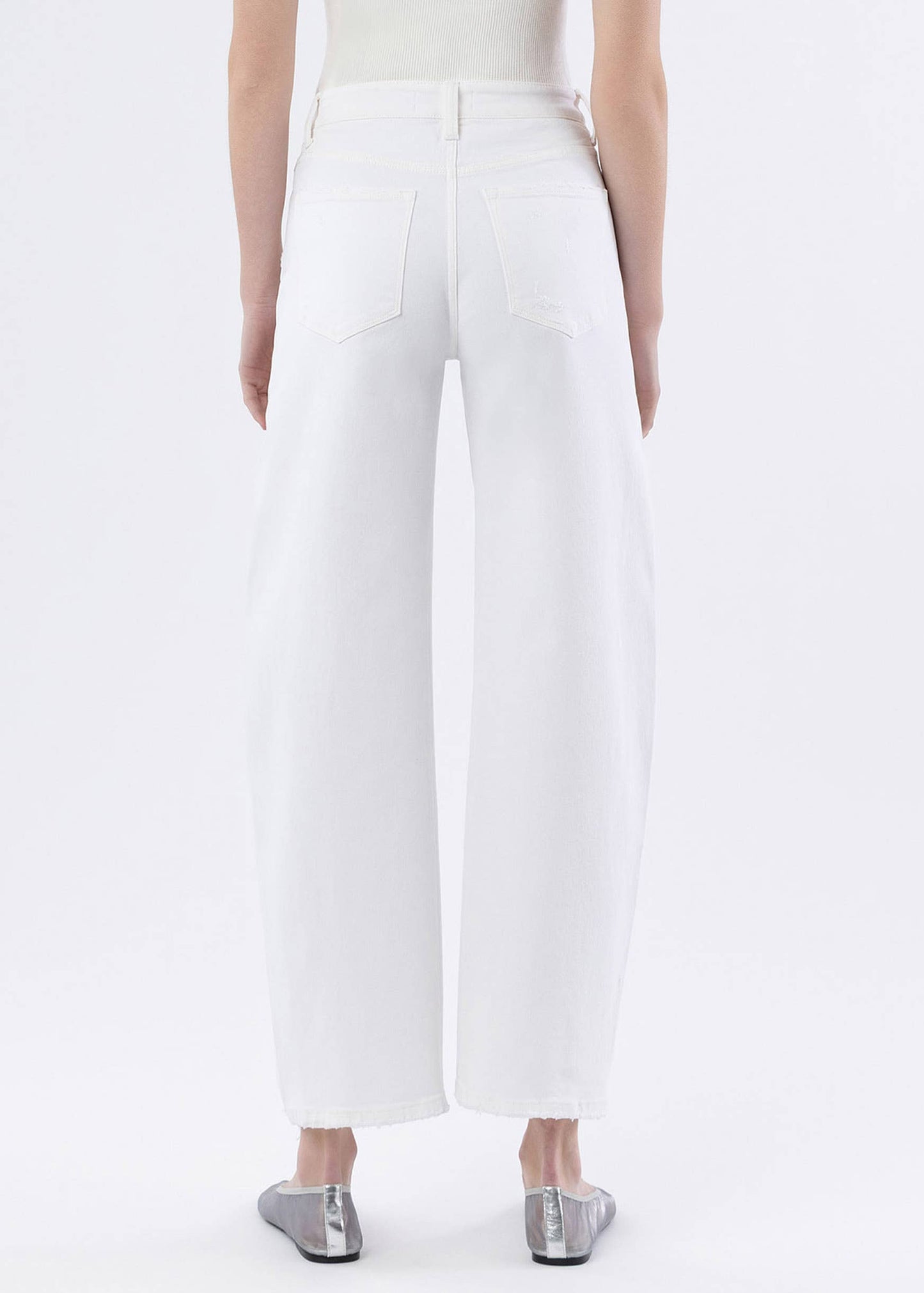 White pants worn by a person on a white background