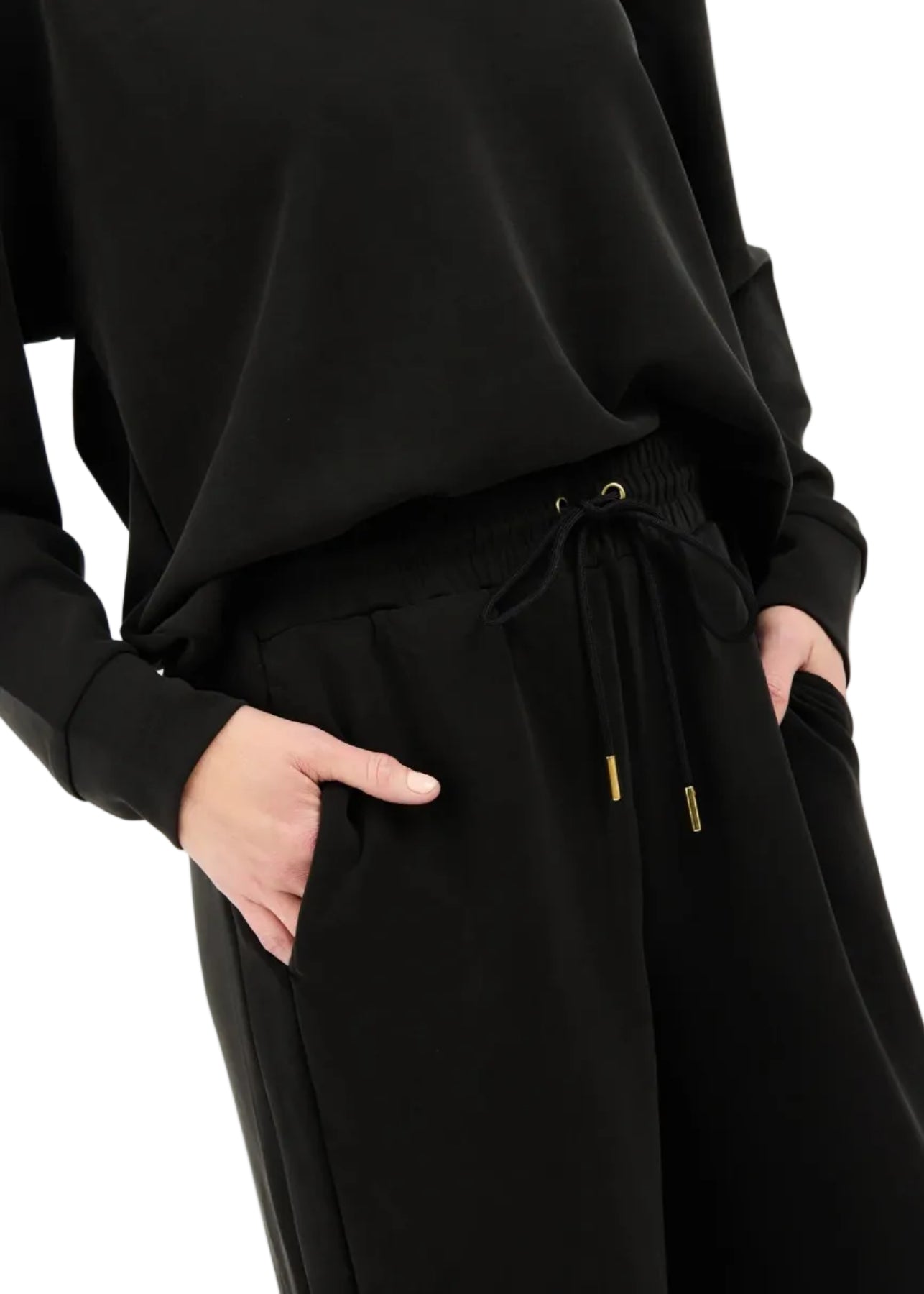 Black outfit with drawstring waist on a white background