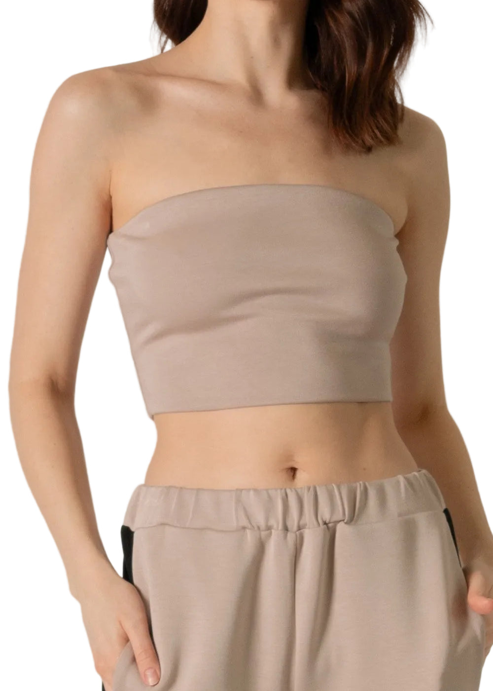 A beige tube top worn by a person, showcasing the garment's fit and color.