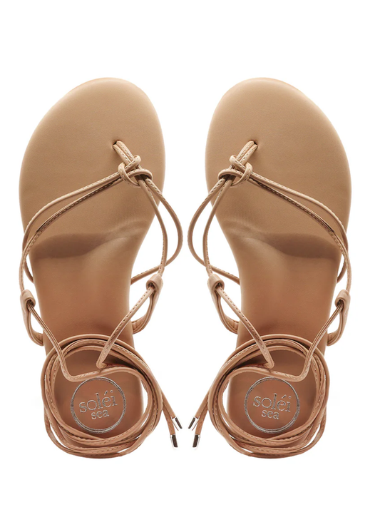 Pair of tan sandals with strappy design on a white background