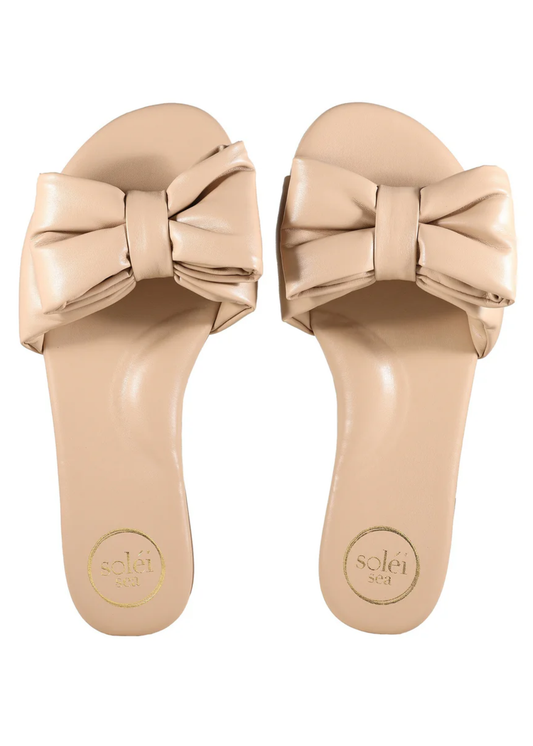 Beige sandals with large bows on a white background