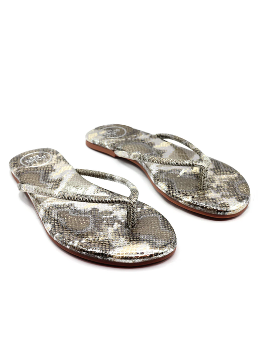 Pair of snake print flip-flops on a white background
