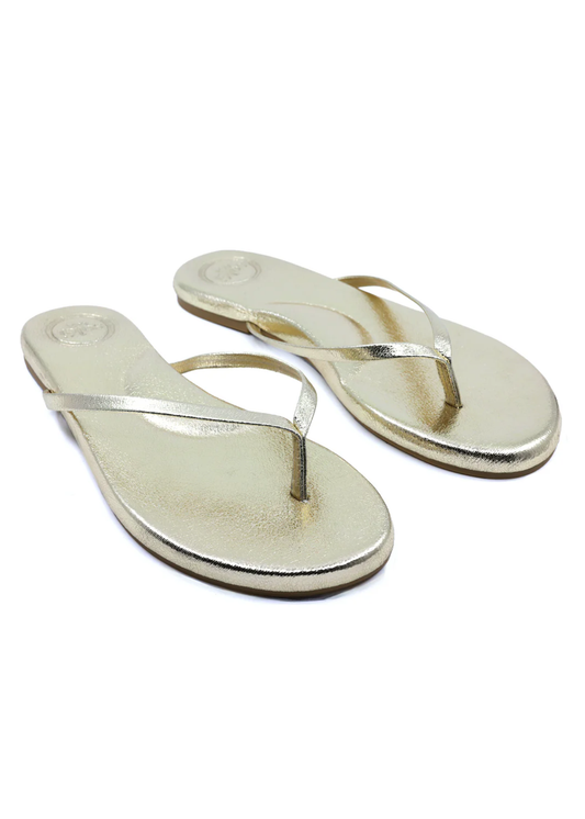 Pair of metallic gold flip-flops on a white background