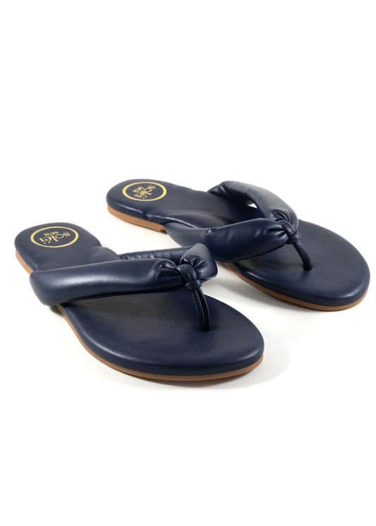 Pair of navy blue sandals with a bow on a white background