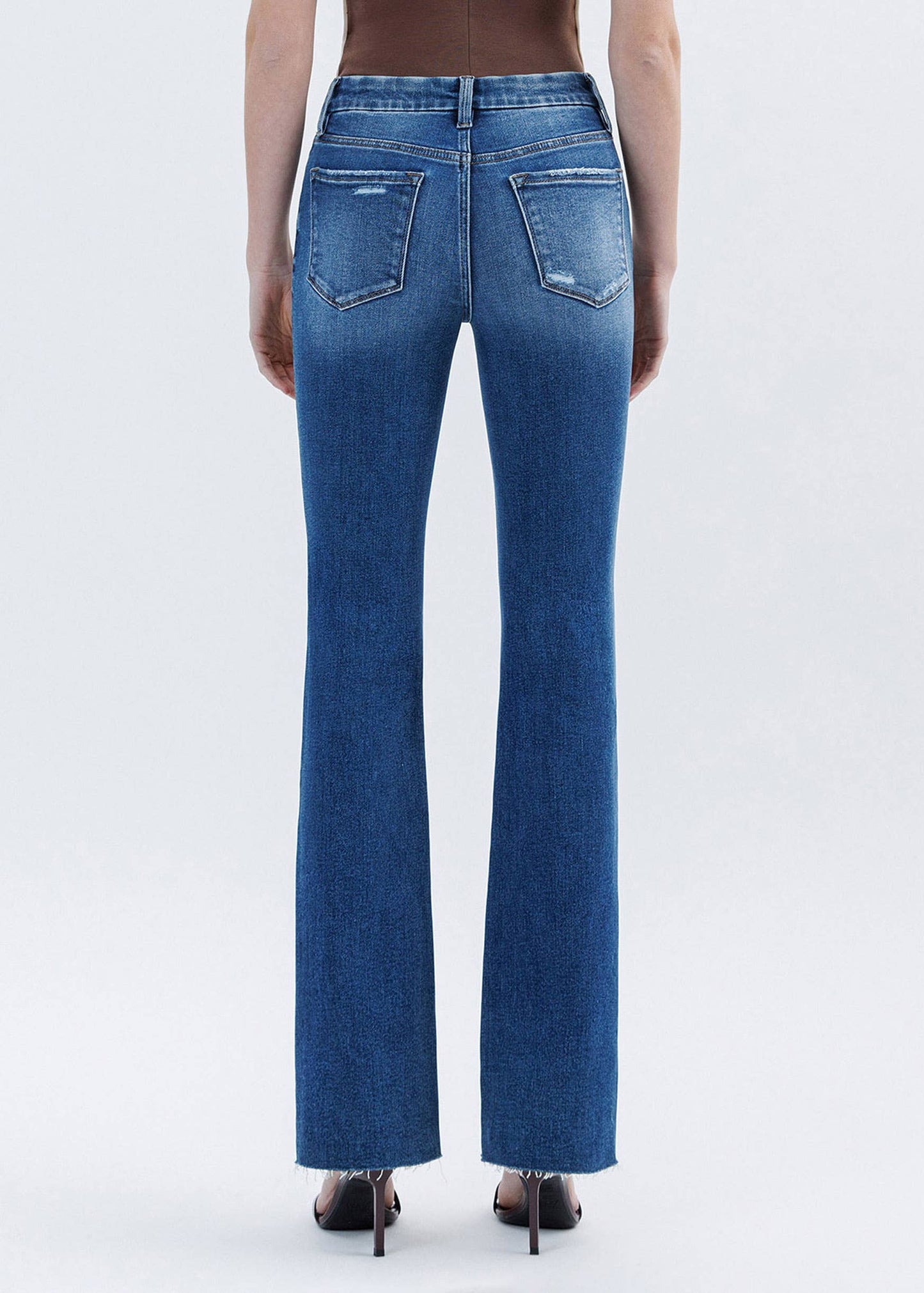 Blue jeans worn by a person on a white background