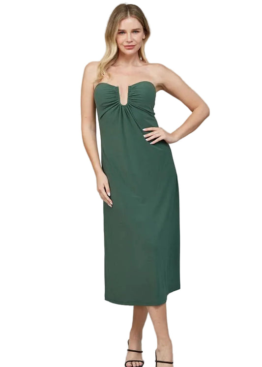 Woman wearing a green strapless dress on a gray background