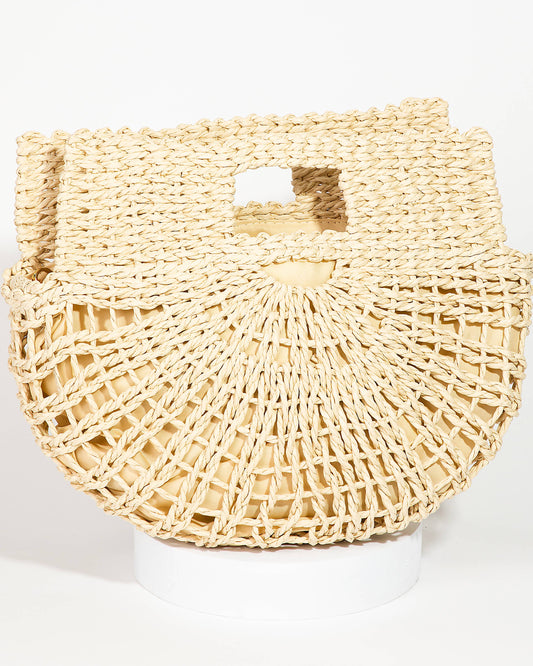 A beige braided semi circle tote bag with a removable shoulder strap.