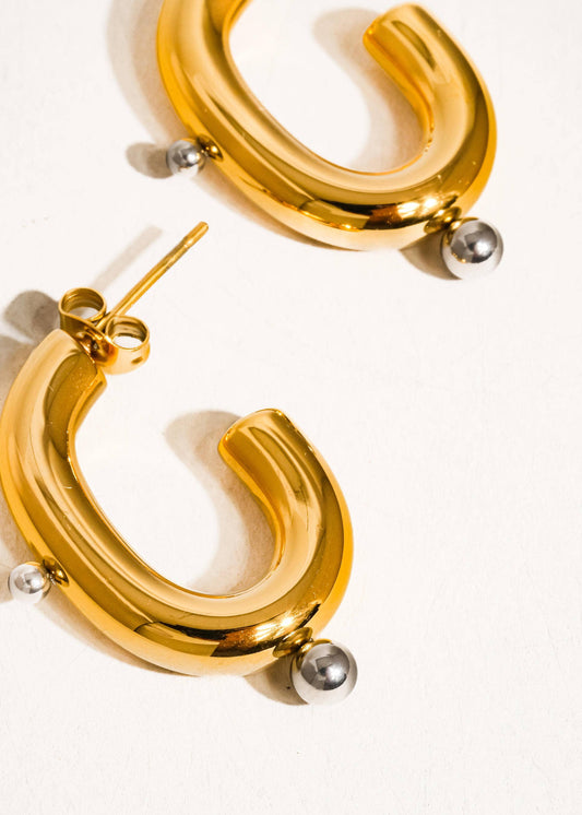 Gold hoop earrings on a white background