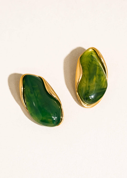 Pair of green stone earrings with gold accents on a white background