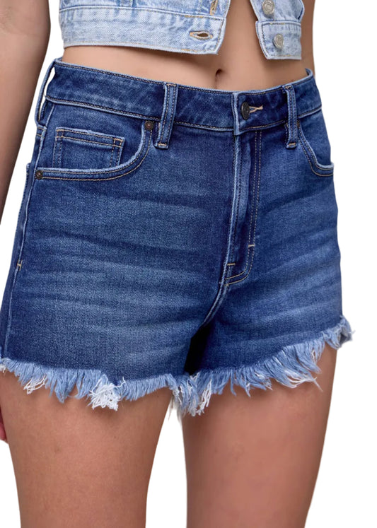 Blue denim shorts worn by a person on a gray background