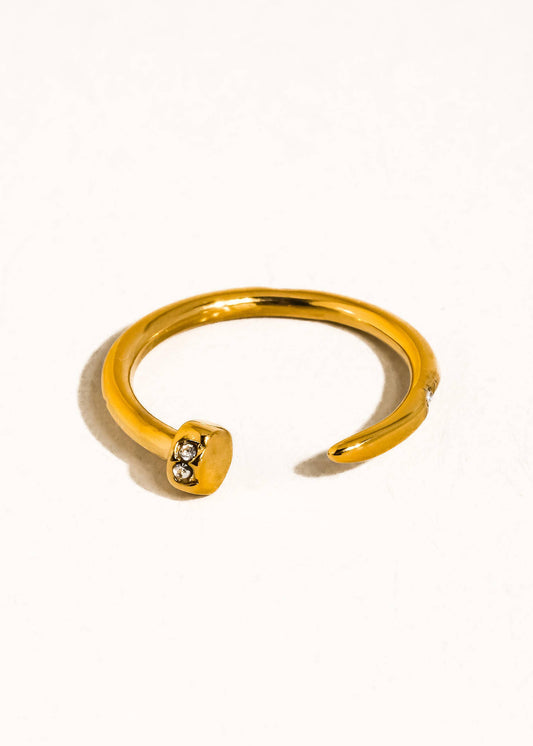Gold ring with a small diamond on a white background