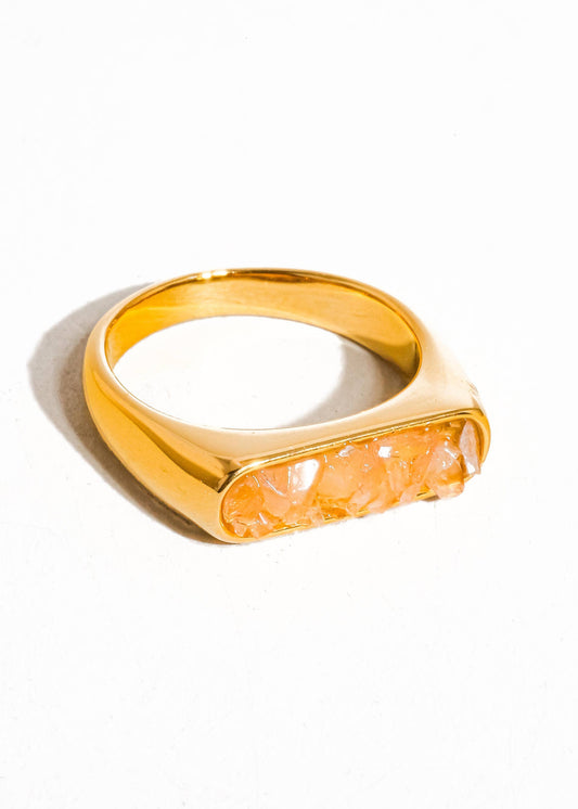 Gold ring with a stone on a white background