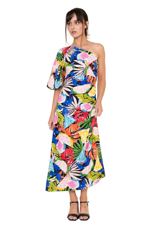 Woman wearing a colorful one-shoulder dress with a floral pattern on a white background