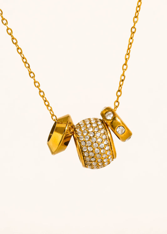 Gold necklace with a pendant on a white background