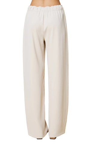 White wide-leg pants on a beige background