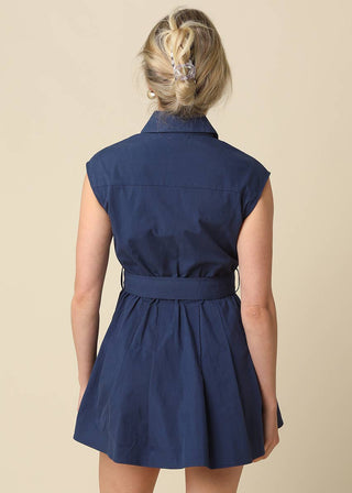 Navy blue sleeveless dress worn by a person on a beige background