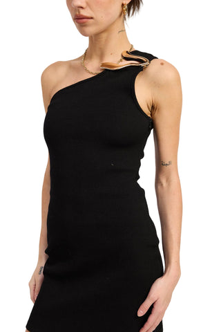 Black one-shoulder dress worn by a person on a white background