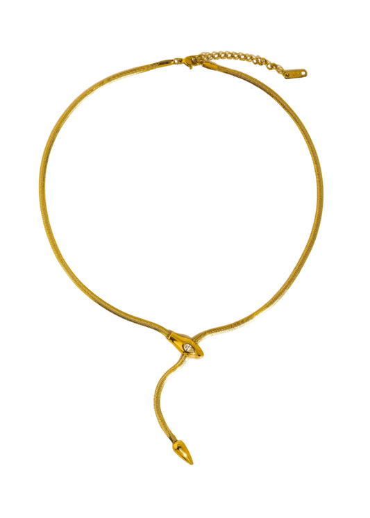 Gold snake lariat necklace on a beige background