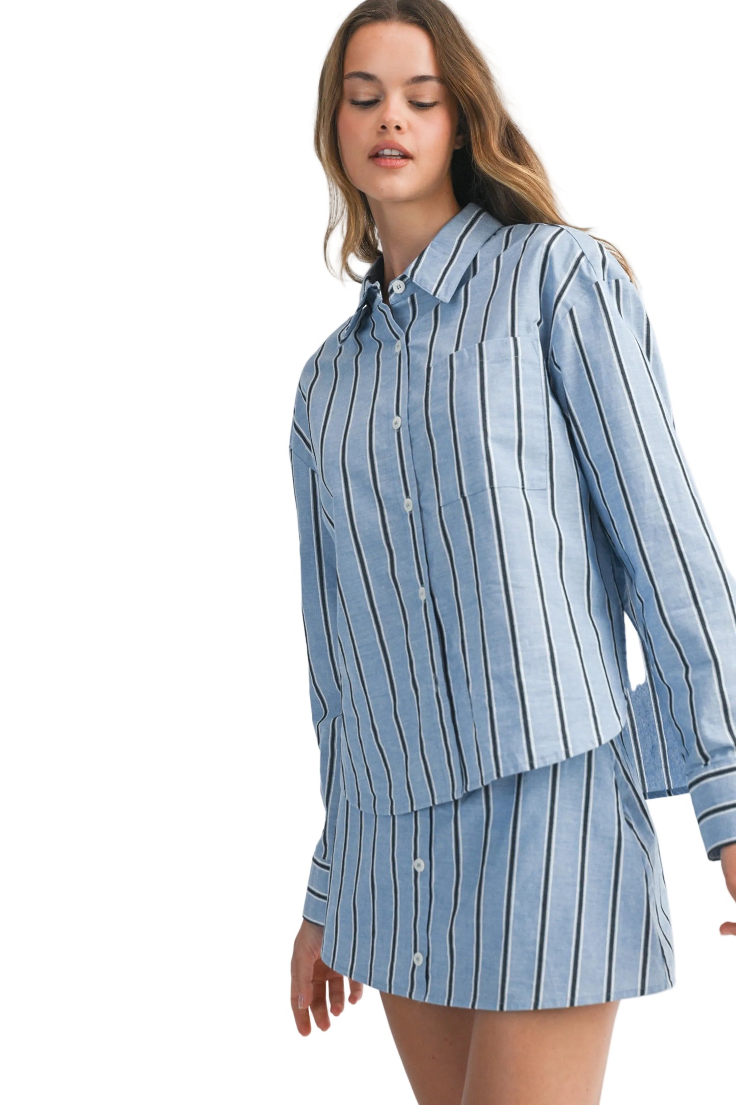 Woman wearing a blue striped shirt and skirt set on a white background