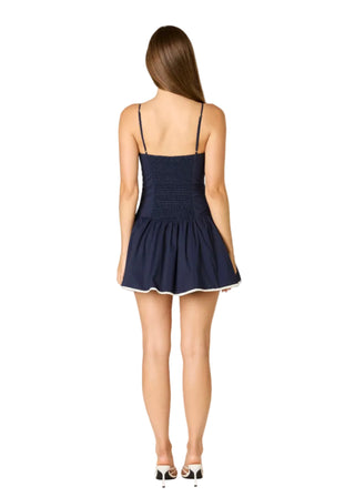 Woman wearing a navy blue dress on a white background