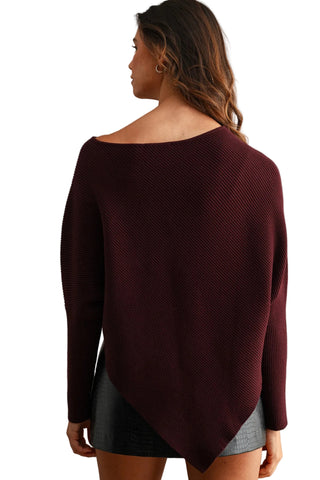 A woman shown from the back wearing a dark burgundy off-the-shoulder knit sweater with a textured waffle pattern and a gray mini skirt, set against a neutral beige studio background.