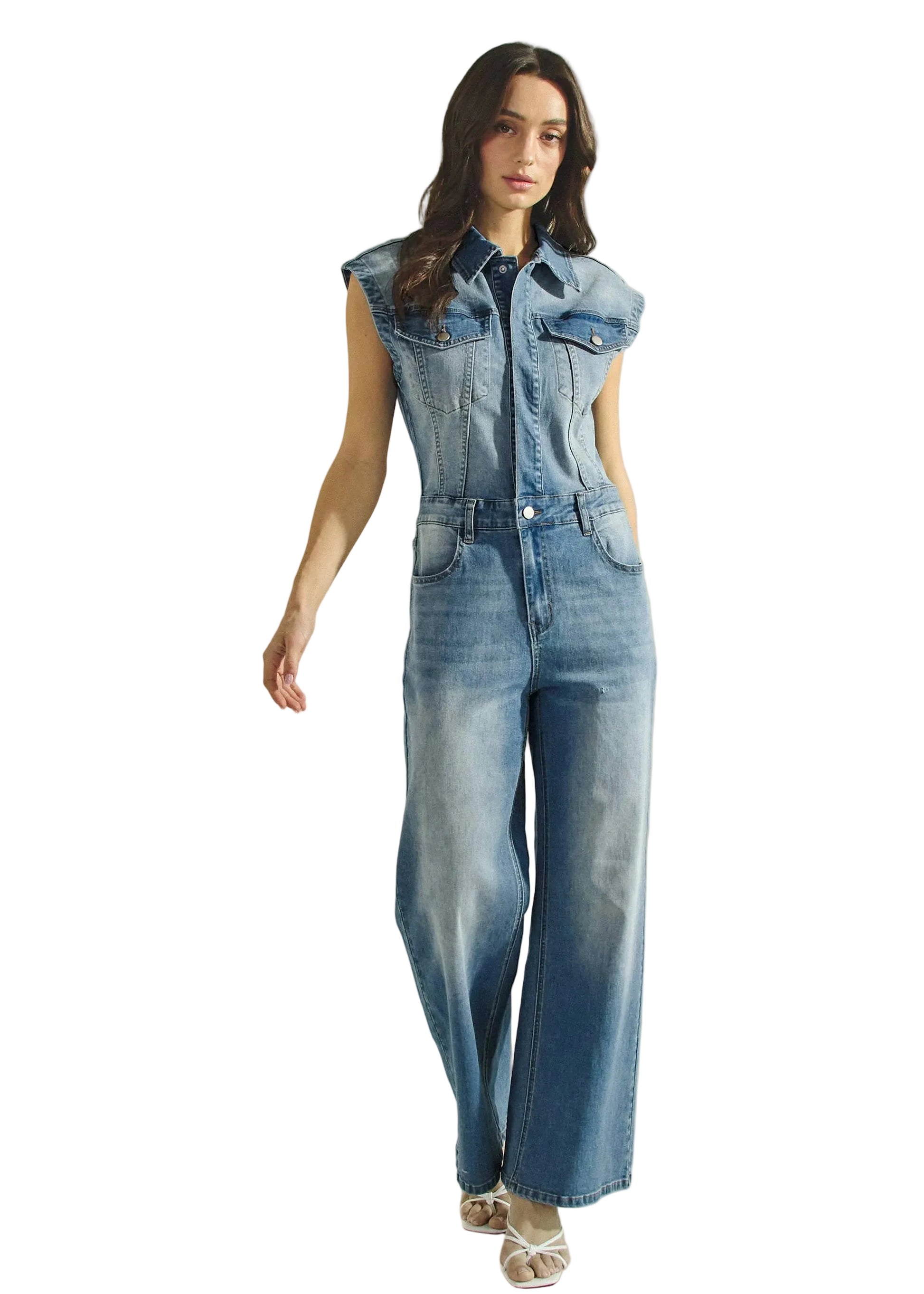 Woman wearing a denim jumpsuit on a white background