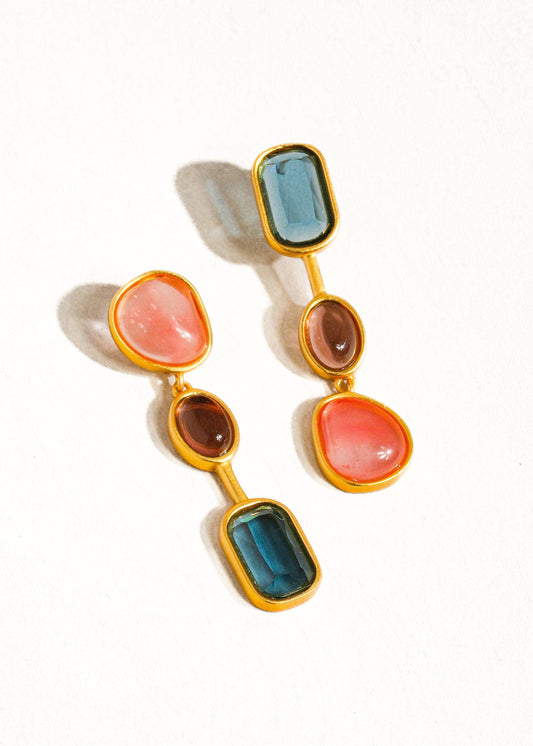 Multicolored drop earrings with gold accents on a white background