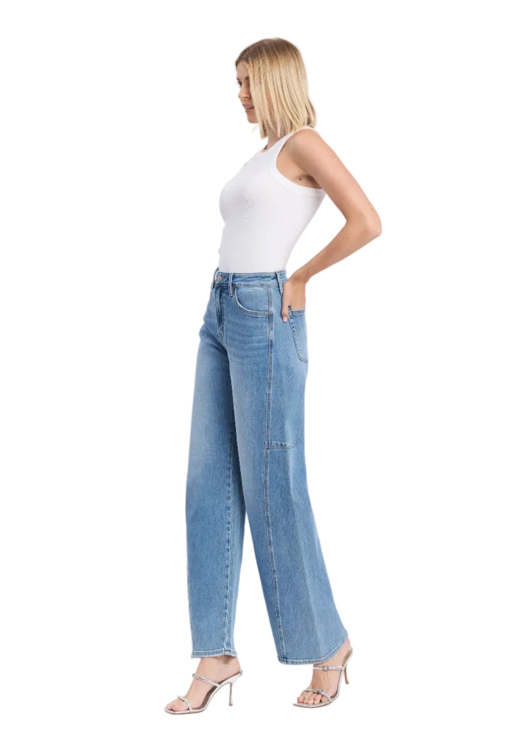 Woman wearing light blue jeans and a white top on a white background