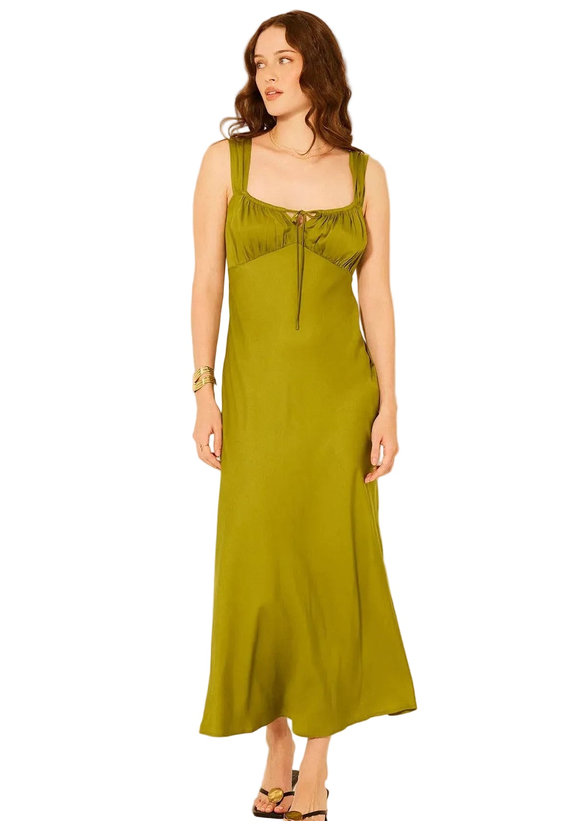 Woman wearing a green slip dress on a white background