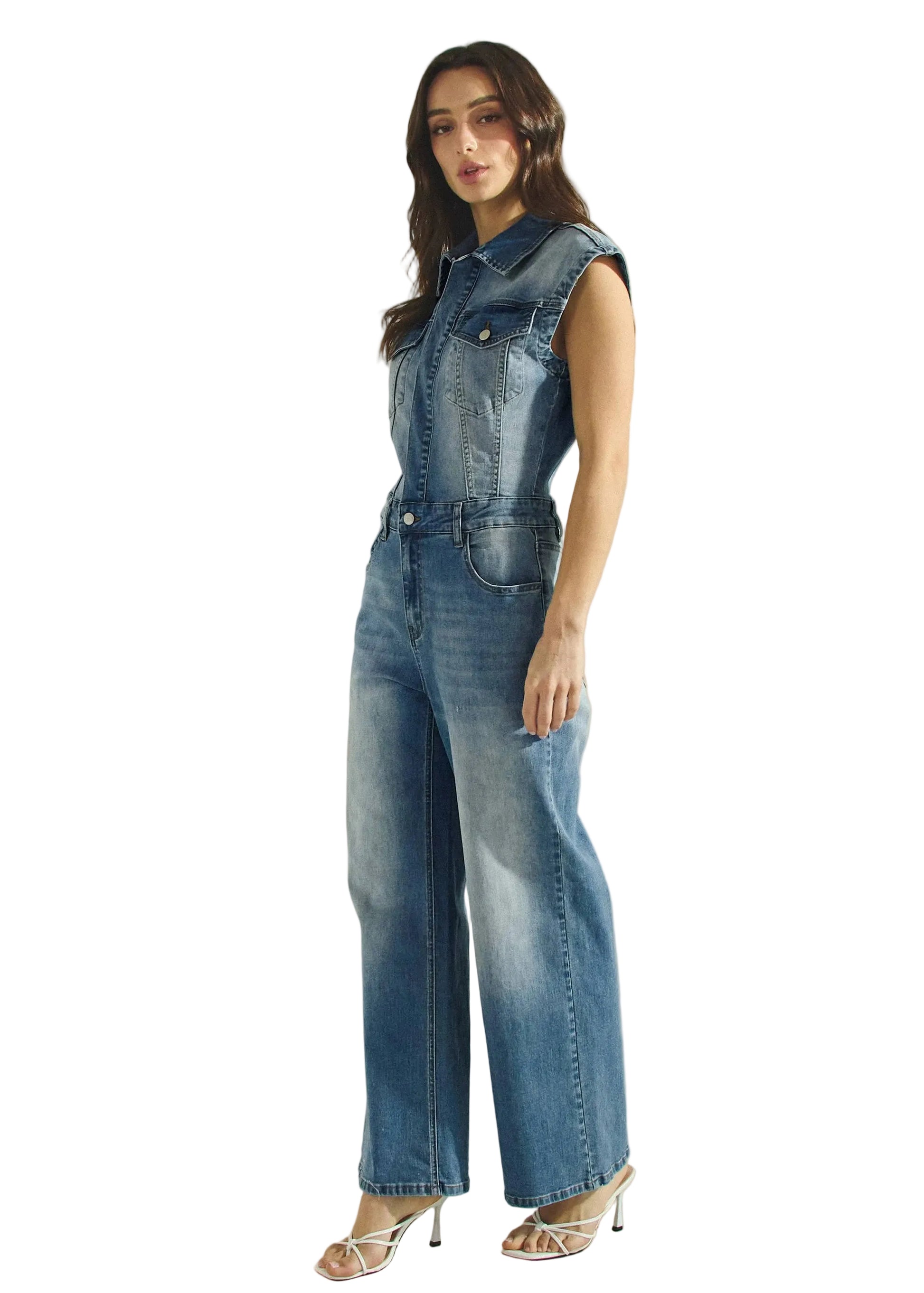 Woman wearing a denim jumpsuit on a beige background