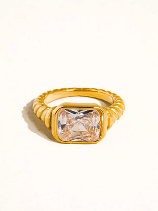 Gold ring with a large diamond on a white background