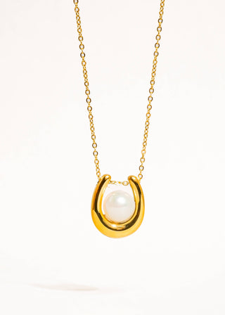 Gold necklace with a pearl pendant on a white background