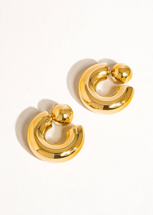 Gold hoop earrings on a white background