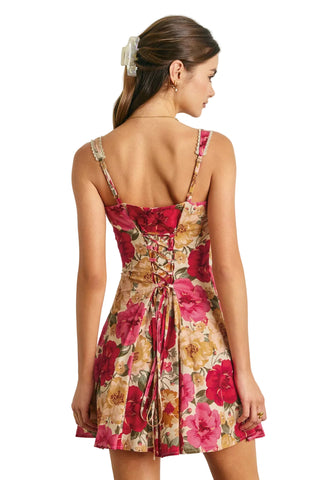 Woman wearing a floral dress with a white background