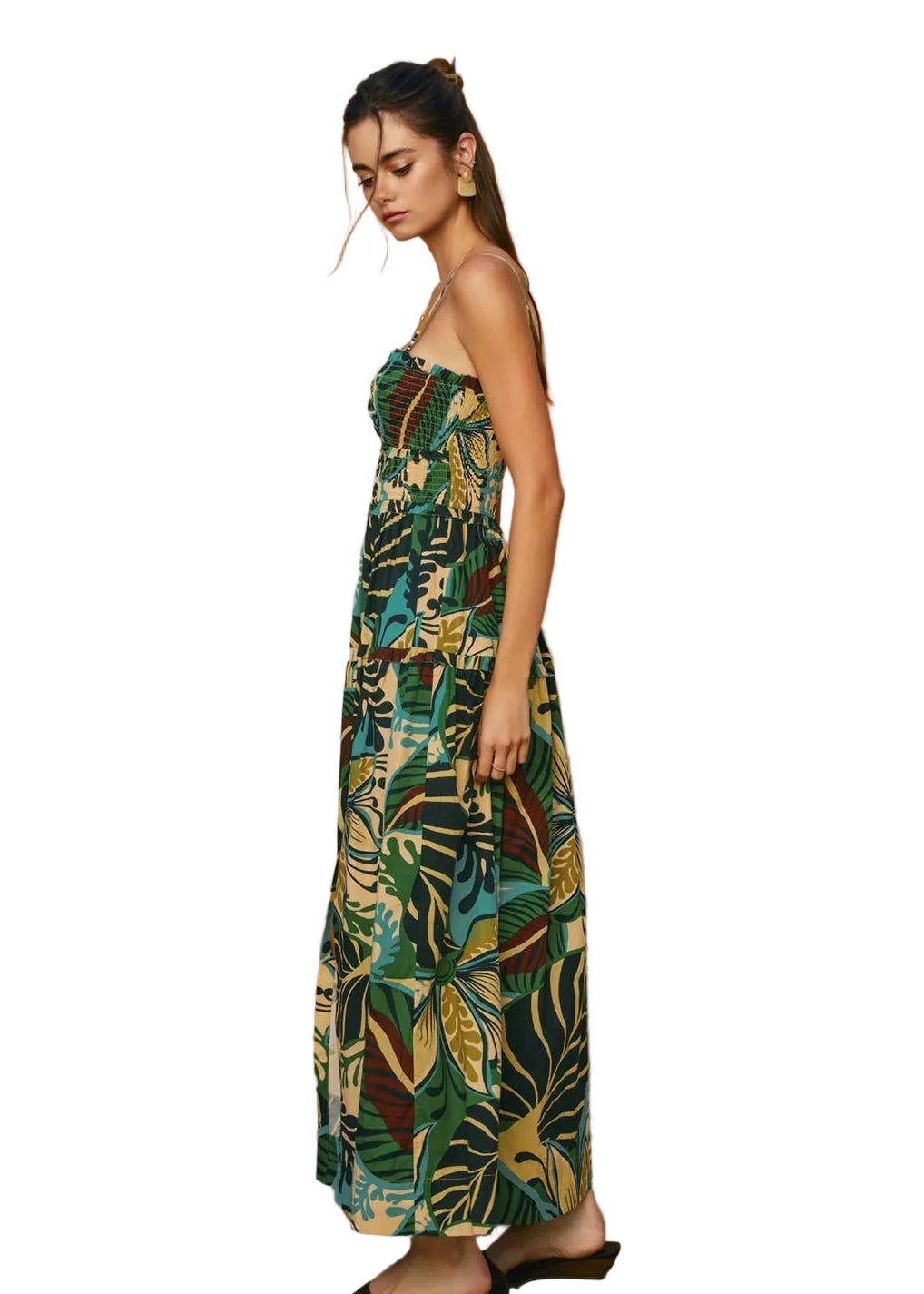 Woman wearing a strapless dress with tropical leaf pattern on a white background