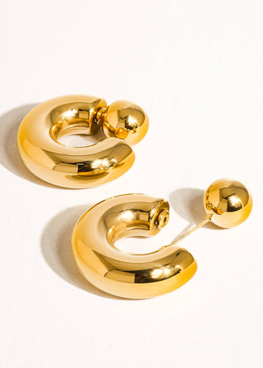 Pair of gold hoop earrings on a white background