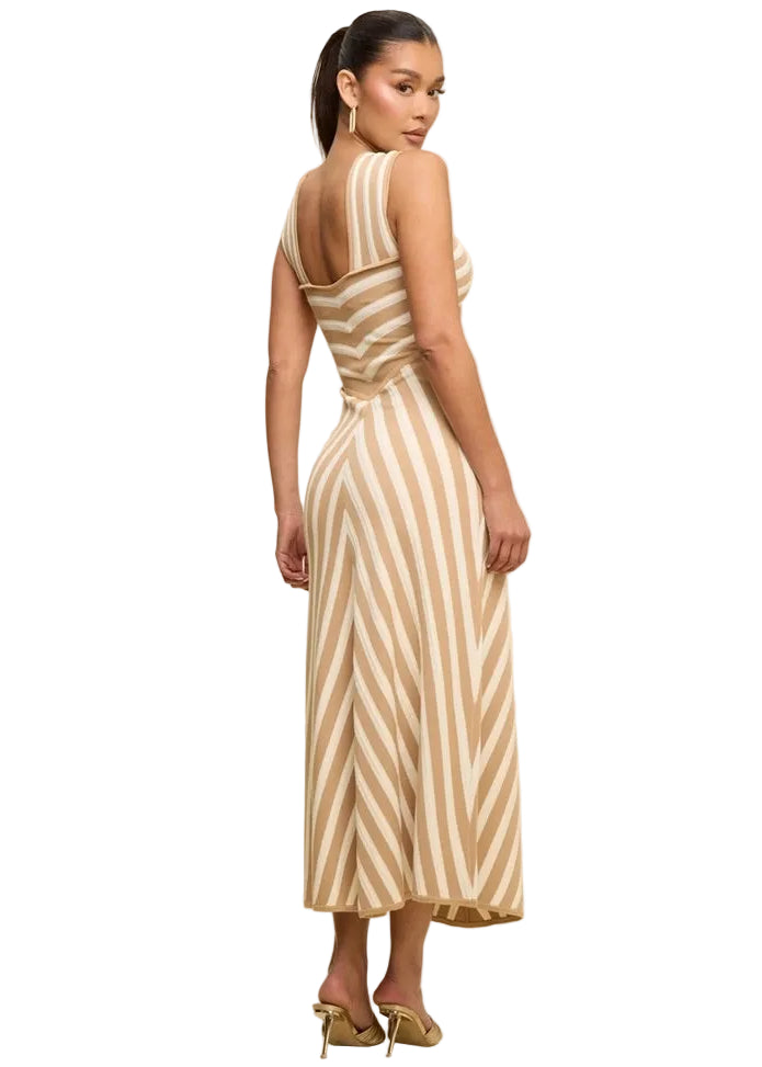 Woman wearing a beige and white striped dress against a beige background