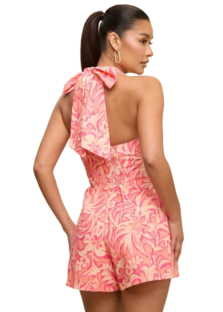Woman wearing a pink floral dress on a beige background
