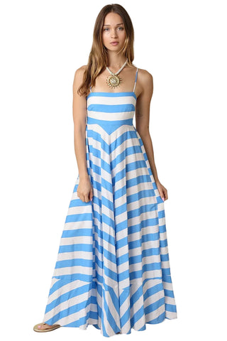 Woman wearing a blue and white striped dress on a beige background