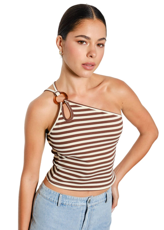 Woman wearing a striped halter top and jeans against a plain background