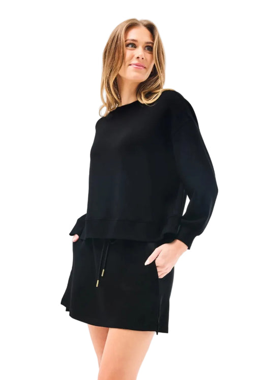 Woman wearing a black outfit on a white background